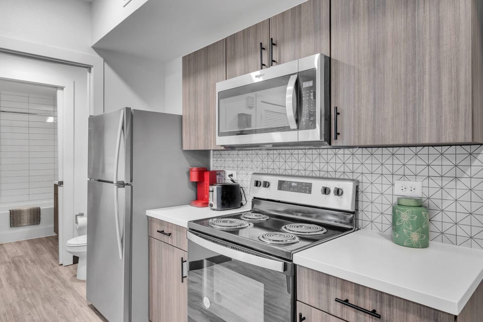 Kitchen includes a refrigerator, microwave, Keurig pod coffee maker, toaster, electric plug-in cooktop & many more!