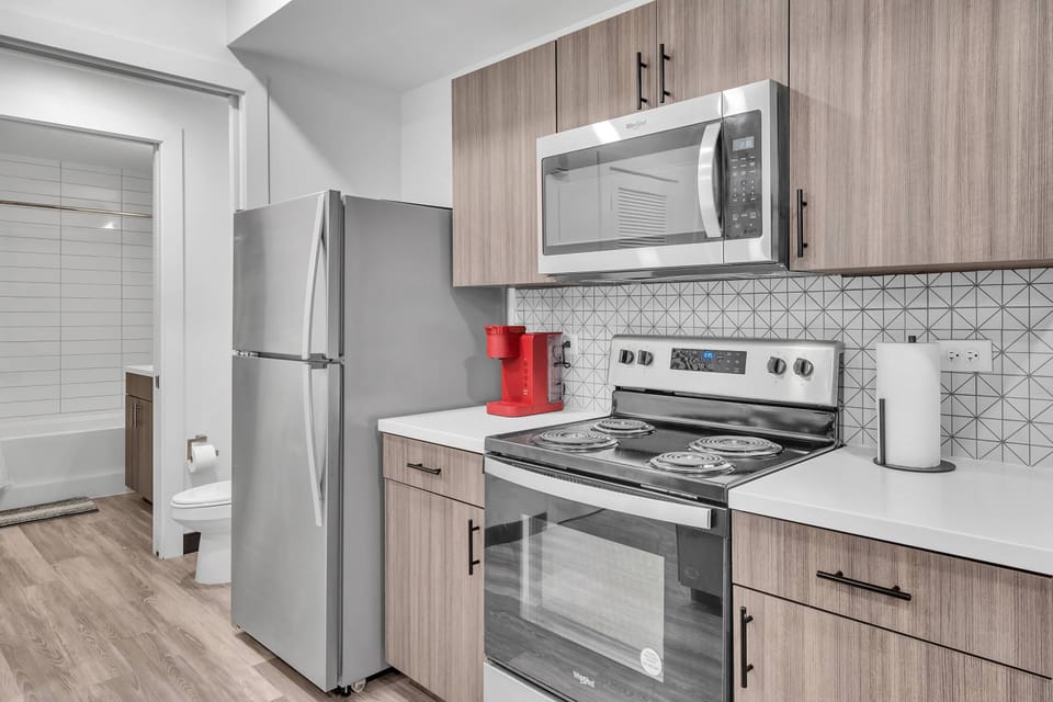 Kitchen area with all stainless steel appliances - microwave, dishwasher, range, refrigerator & Keurig pod coffee maker!