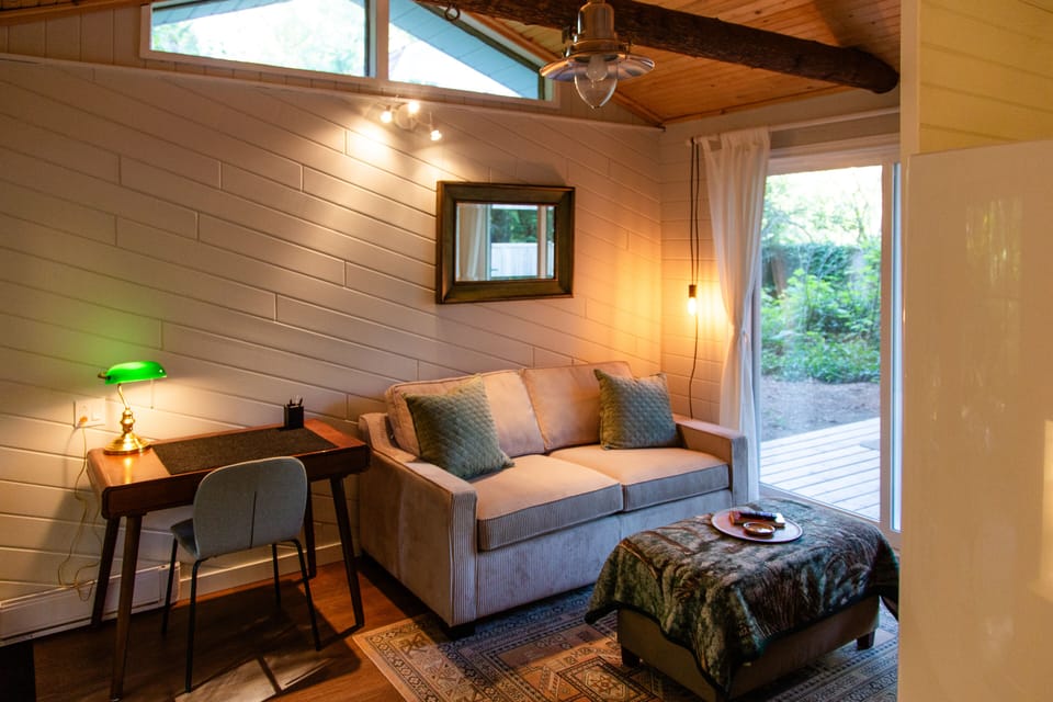 The pull-out couch and workspace with vaulted ceiling above.