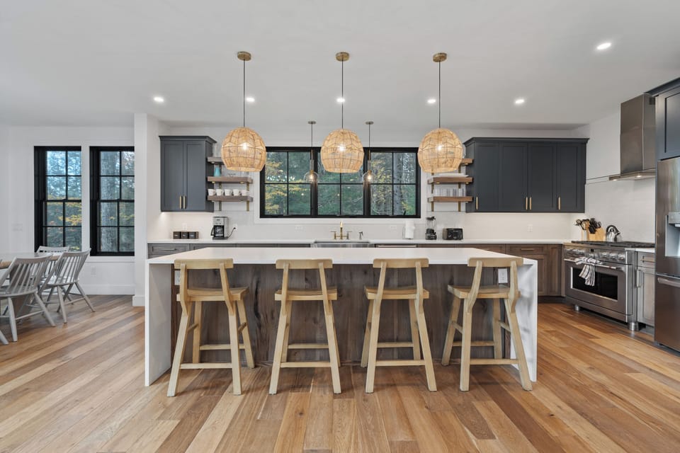 Spacious kitchen features a large island with barstool seating.