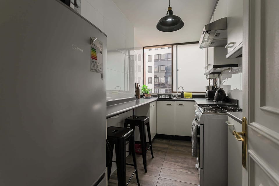 Sleek and modern kitchen with ample natural light, perfect for culinary enthusiasts.