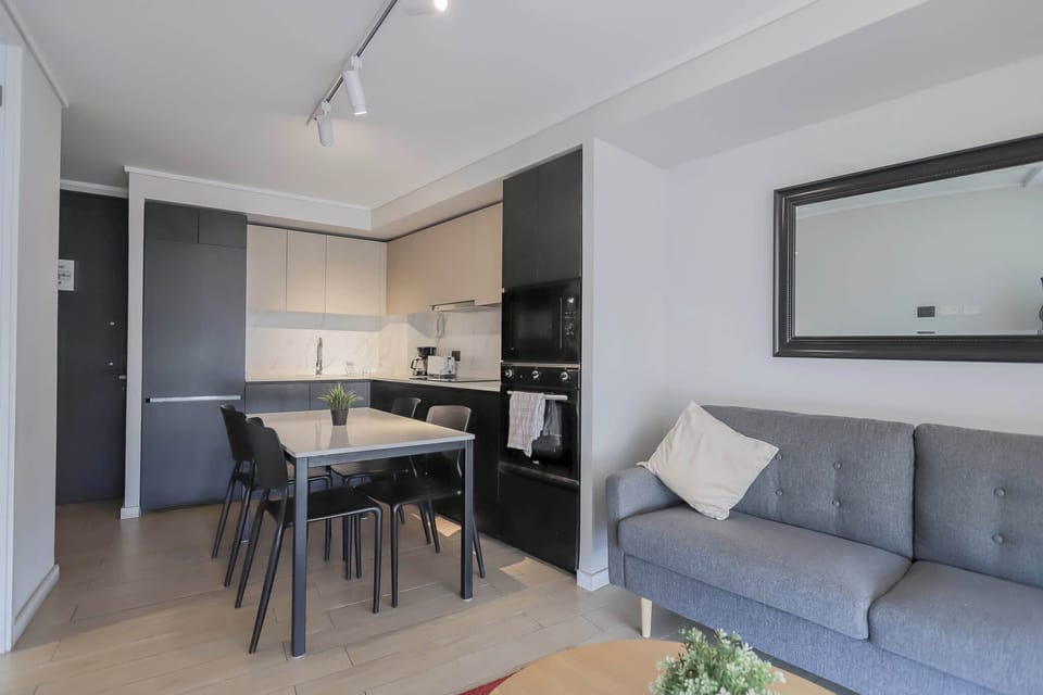 Experience modern comfort in this stylish studio apartment with a fully equipped kitchen and cozy living area.