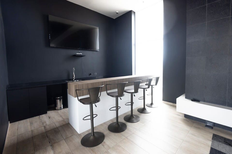 Enjoy a sleek, modern bar area perfect for relaxing and entertaining.