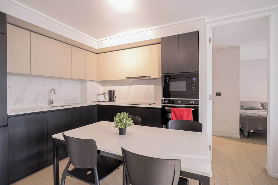Sleek and modern kitchen with dining area, perfect for enjoying meals in style and comfort.