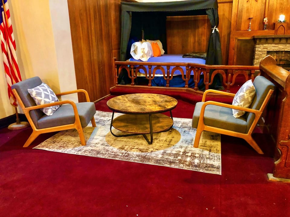 Pour your coffee and take the corner seat framed by original woodwork — the fireplace is nearby, the conversation is easy, and the morning is yours. 
