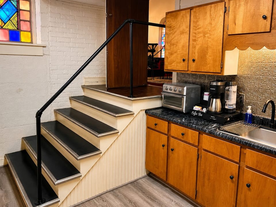 The kitchen is tucked to the side of the main sanctuary, just down a short set of wide steps and just off the sitting area with its television and electric fireplace for relaxing.  When you're relaxing, a snack or a cup of hot cocoa are just steps away.