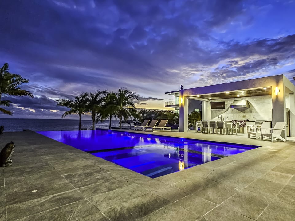Twilight view infinity pool and dining area