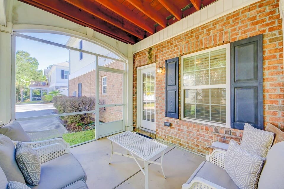 Cozy screened patio with comfy seating, perfect for stylish outdoor relaxation.