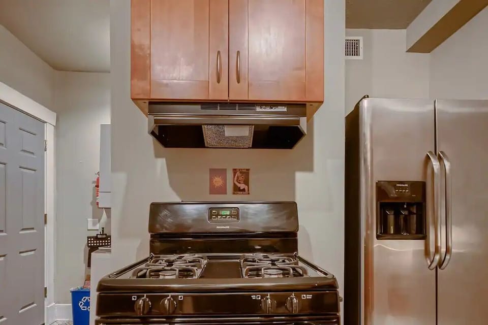Lower kitchen w/ dishwasher, microwave, gas range, kettle, side by side fridge