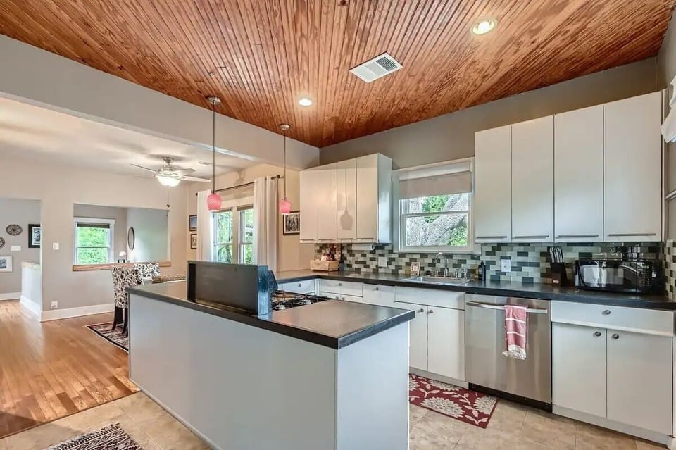 Upper level kitchen, fully stocked, with door to upper deck overlooking backyard