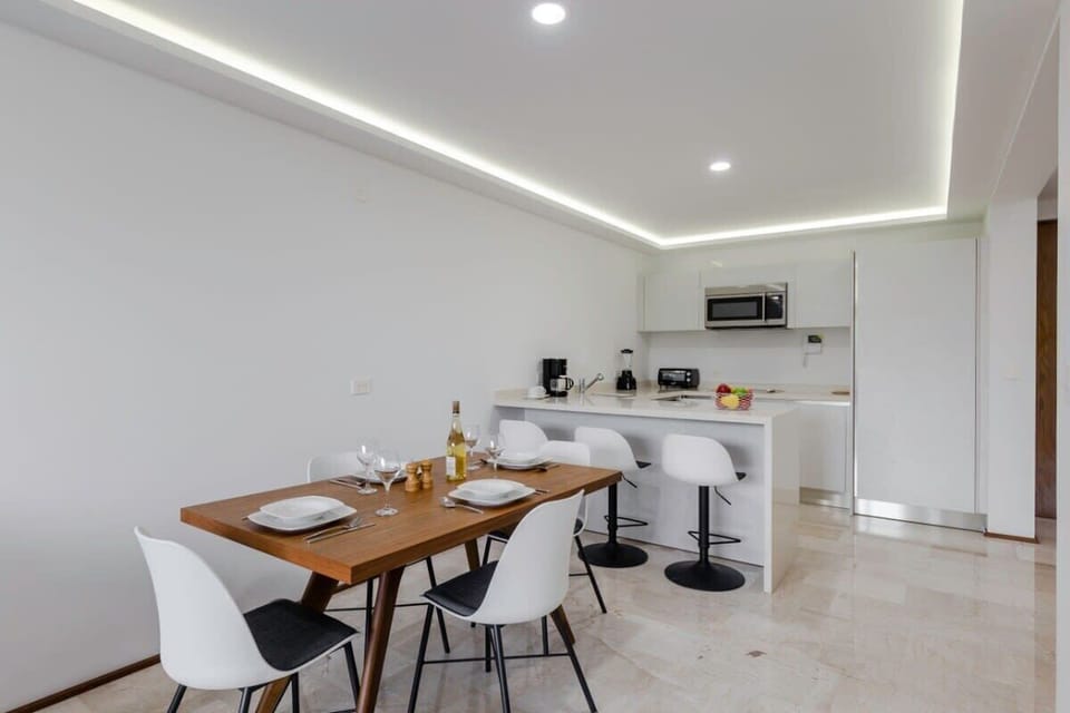 A chic dining space with modern lighting and a cozy atmosphere.