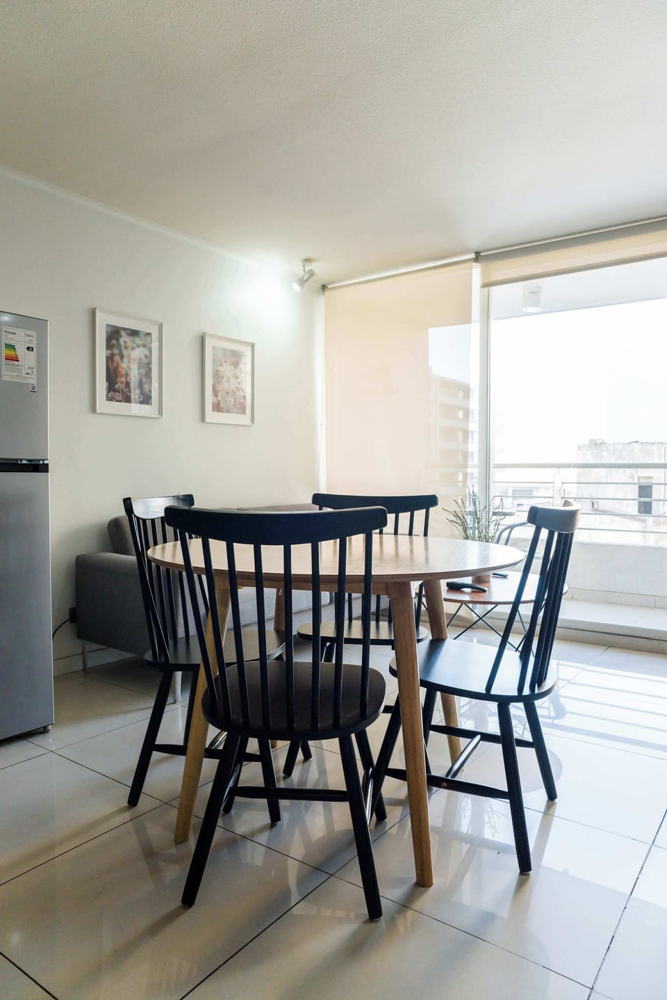 Bright dining area with city views, perfect for cozy meals in a modern setting.