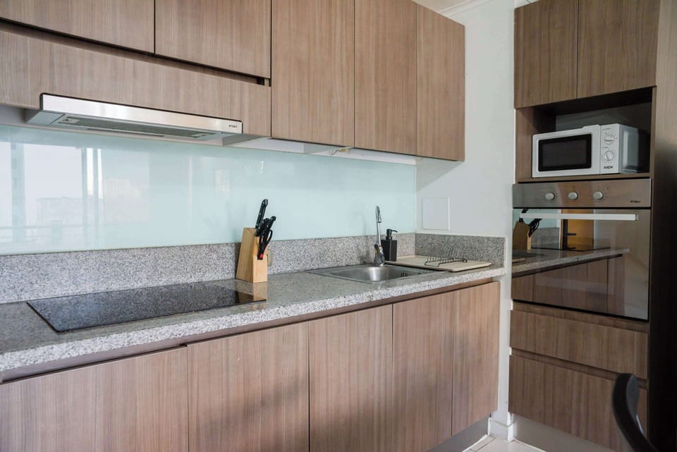 Sleek and modern kitchen with all essentials for a comfortable stay. Perfect for cooking up a meal after exploring the city.