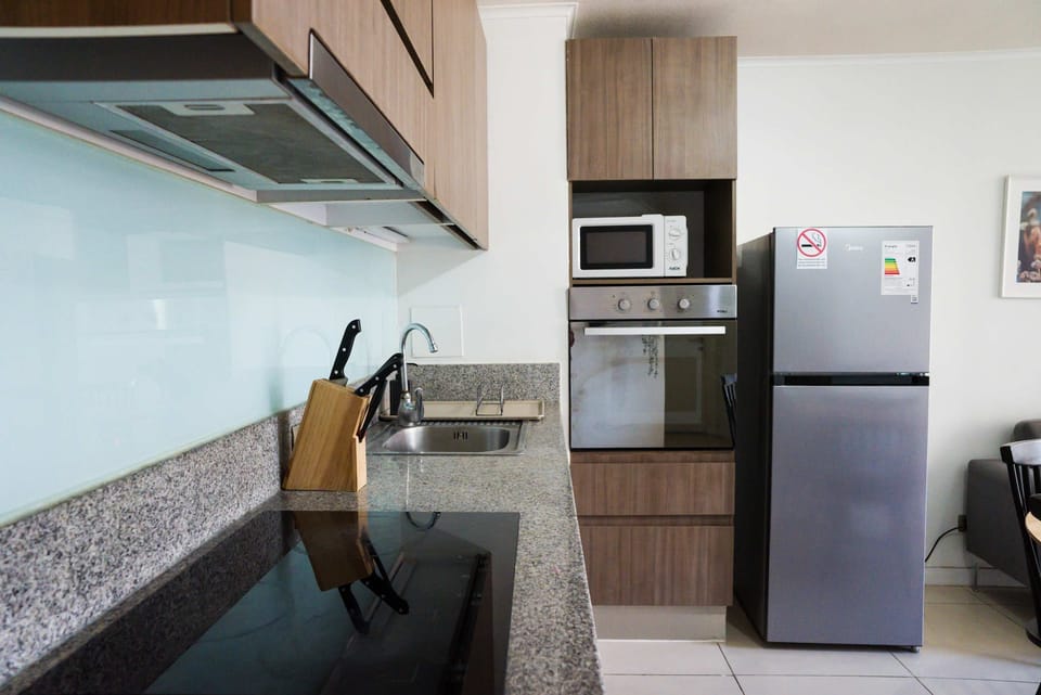 Modern kitchen with sleek appliances and ample counter space, perfect for preparing meals during your stay.