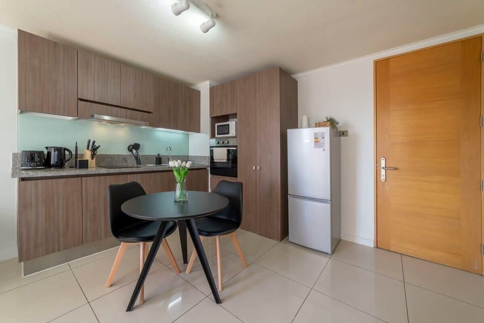 Sleek and modern kitchen with stylish dining area, perfect for cozy meals and culinary adventures.