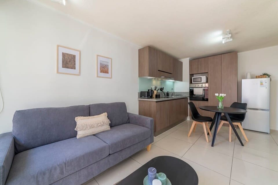 Cozy living area with a modern kitchen, perfect for relaxing and dining in style. Enjoy the comfort and convenience of this inviting space.