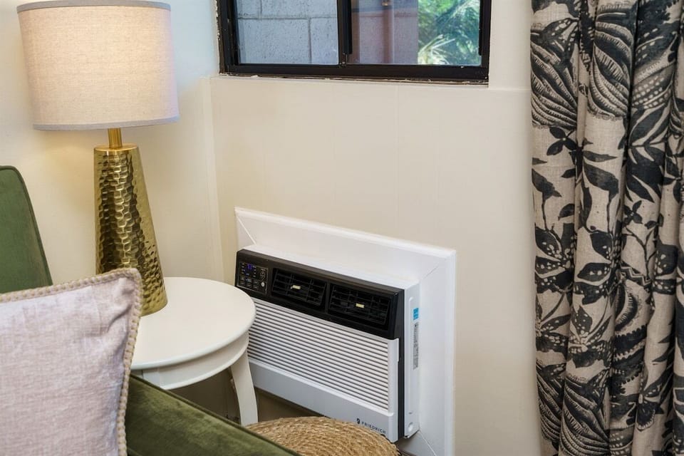 Separate air conditioning units in both the living room and the bedroom