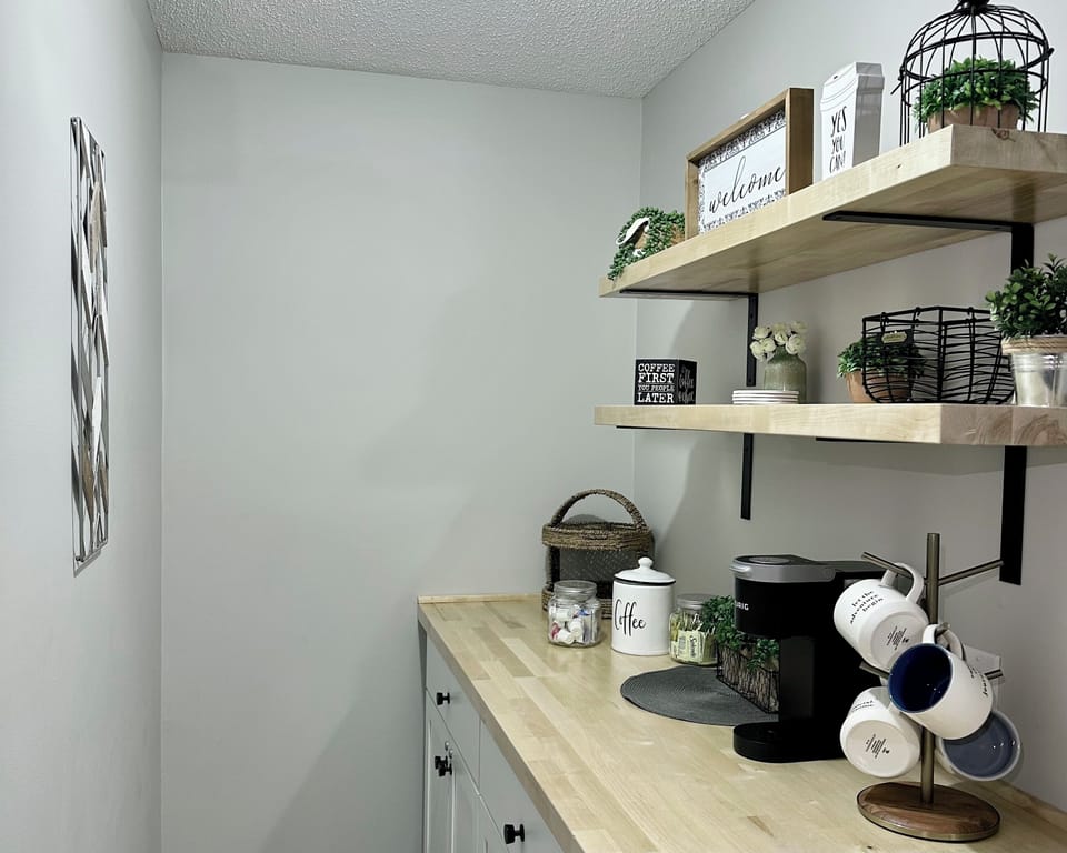 Lower level coffee bar fully stocked with Keurig, k-cups, creamer and sugars