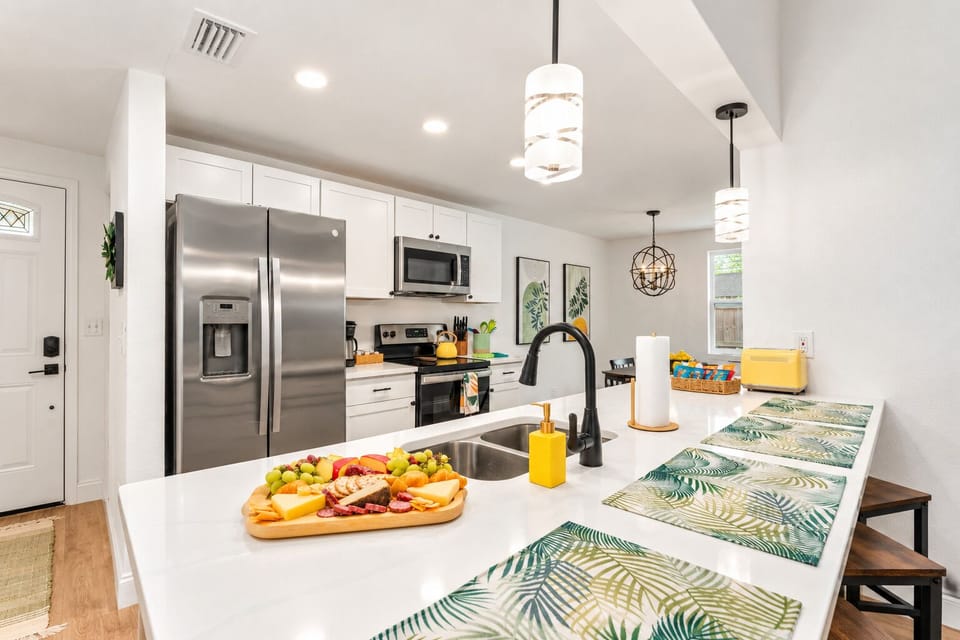 Cook and gather around the island in the fully stocked open kitchen