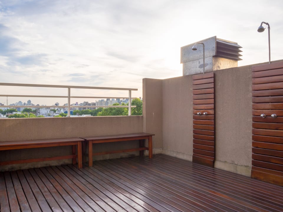 An open rooftop deck pairs bench seating with a broad look across the city.