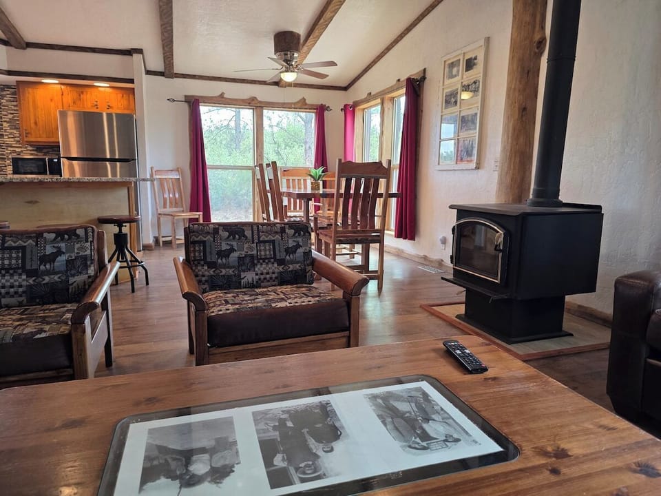Living room opens to the kitchen bar, with a wall-mounted smart TV and cozy