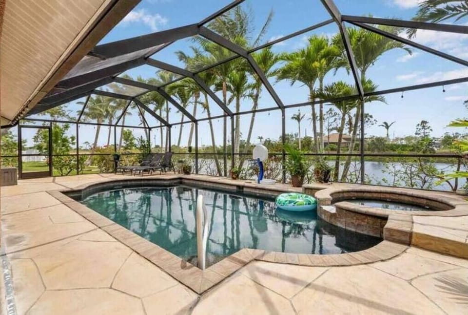 Private covered lanai with heated saltwater pool/spa overlooking the canal