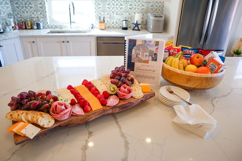 Welcome charcuterie board & bowl of fruits, chips & cereal