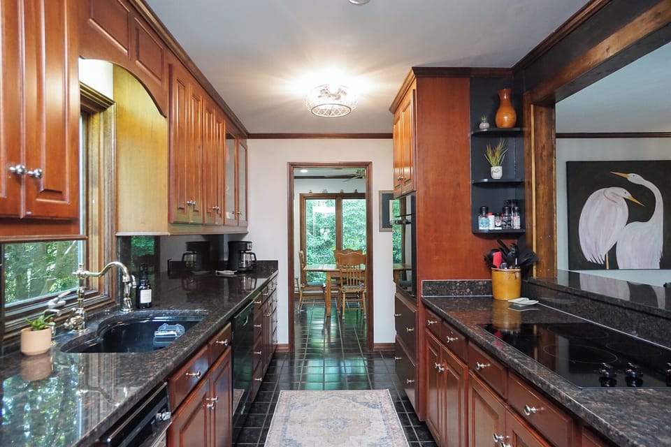 Standing in kitchen; look straight to the sunroom, and right to the dining room.