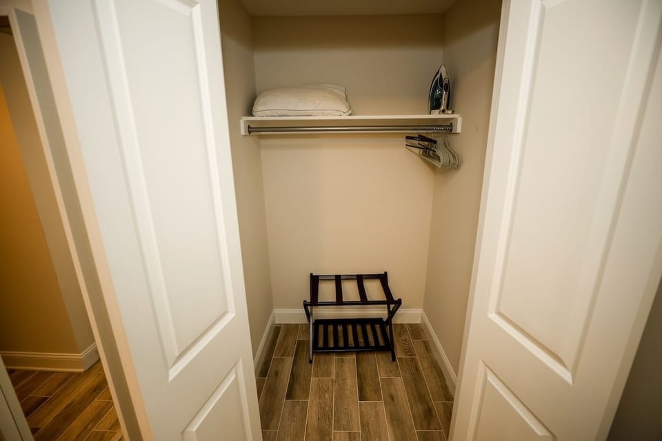 Closet in second bedroom with luggage rack.