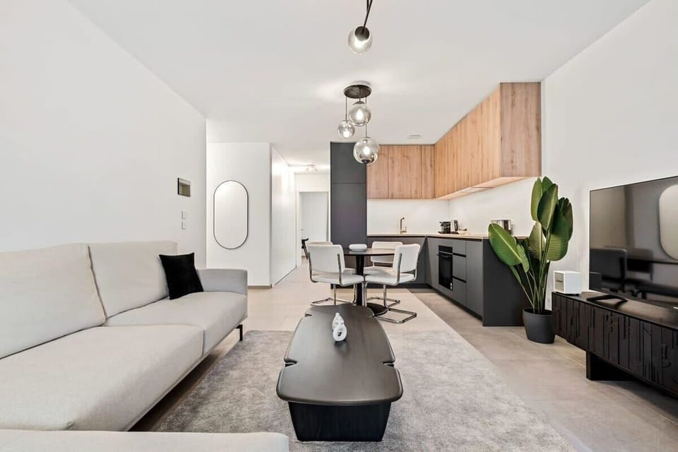 Relax in our minimalist living room with all the comforts of home, a perfect blend of function and style for your stay.
