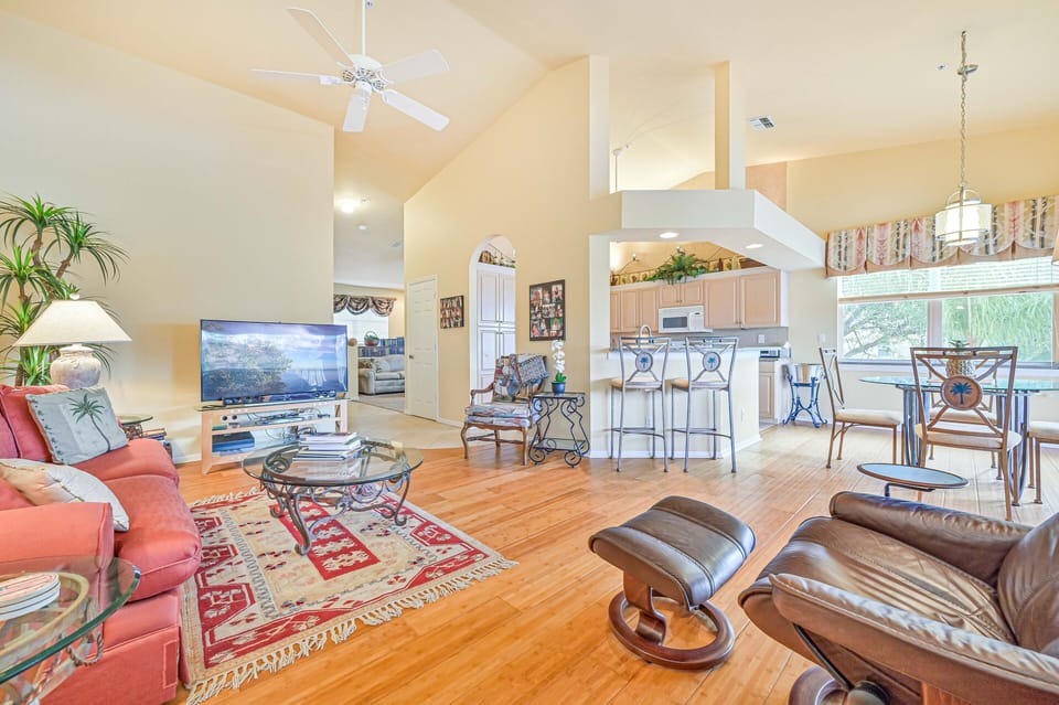 BF201 - Living room with 55" curved TV. Sliding doors open up to the oversized balcony with lake and golf course view