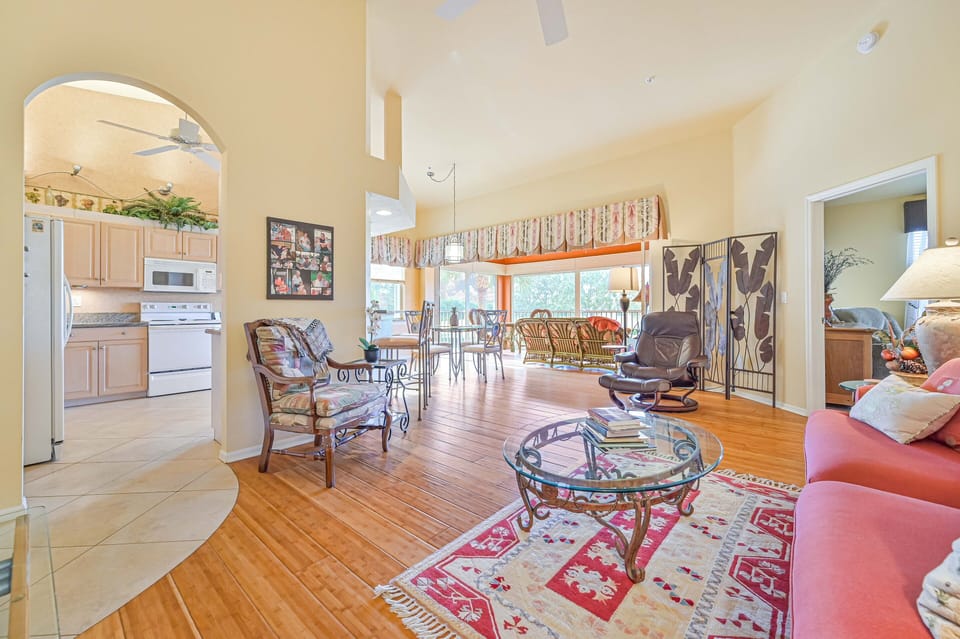 BF201 - Living room with 55" curved TV. Sliding doors open up to the oversized balcony with lake and golf course view