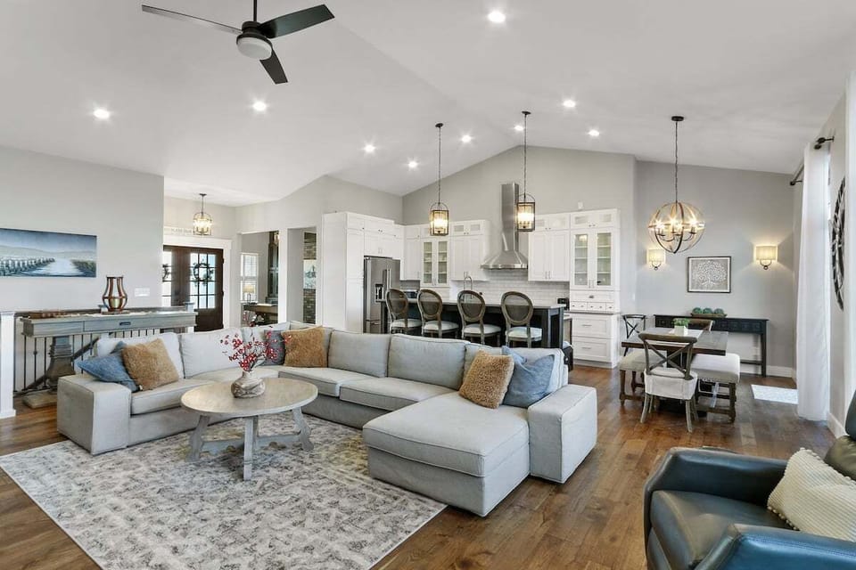 Open concept living room with fireplace to kitchen. Breakfast bar seating for four.