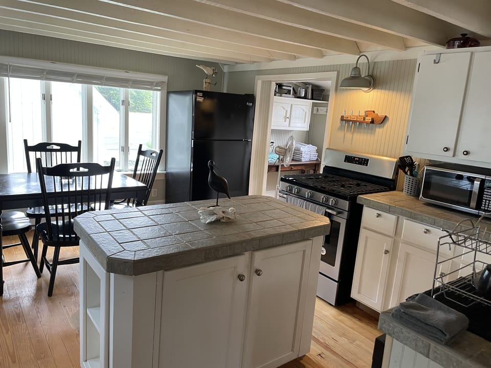 Full size kitchen with a smaller dishwasher.
