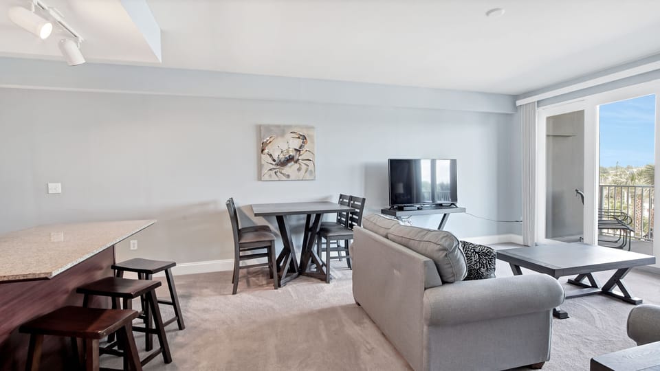 Open living and dining area with modern furnishings and natural light.