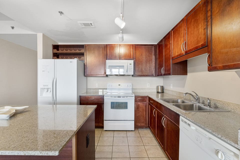 Modern kitchen with granite countertops and wooden cabinetry