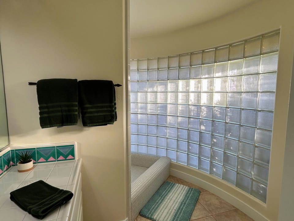 Large master bathroom shower with glass block wall