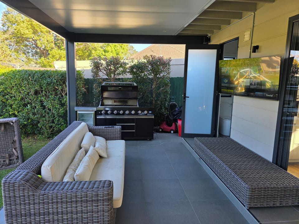 large outdoor TV & lounge with bathroom & laundry