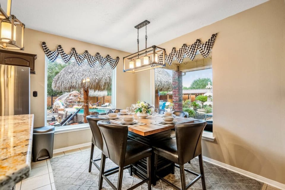 Cozy dining nook with pool views, modern lighting, and seating for six