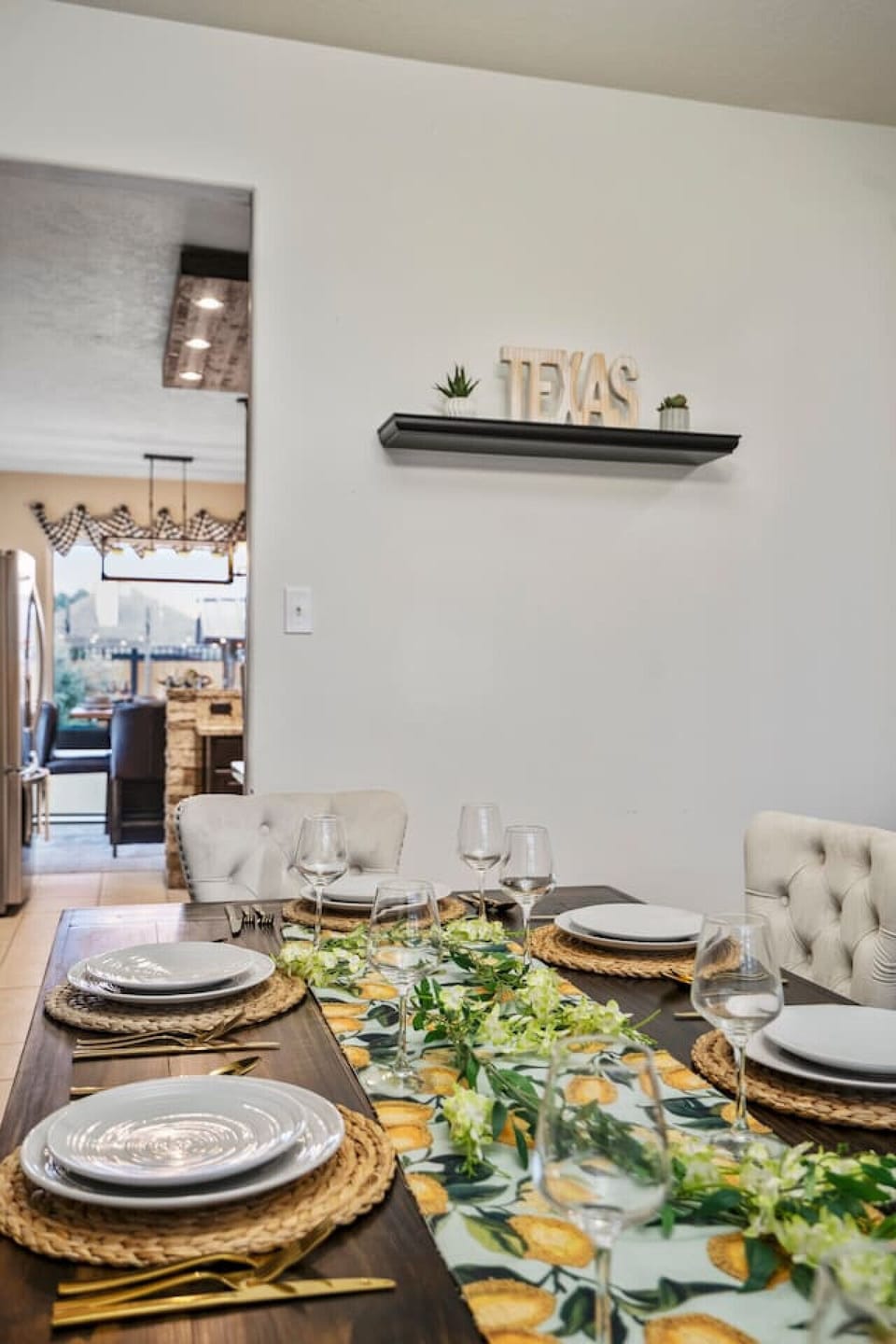Charming dining setup with floral runner, elegant place settings, and Texas-themed decor