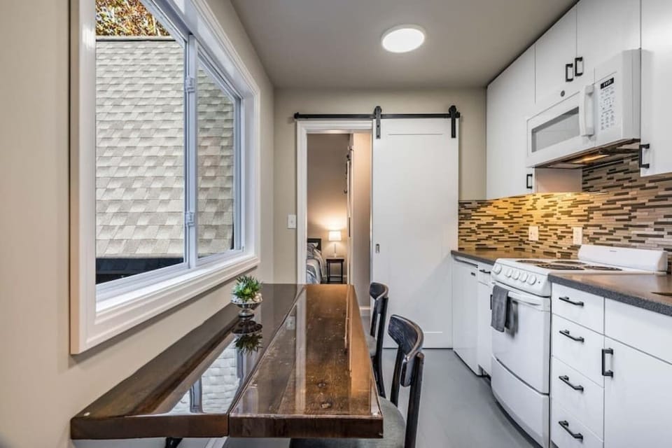 The thoughtfully designed kitchen is common space shared between you and your guests with a beautiful handmade table that can seat 2 or open up to comfortably seat 4.