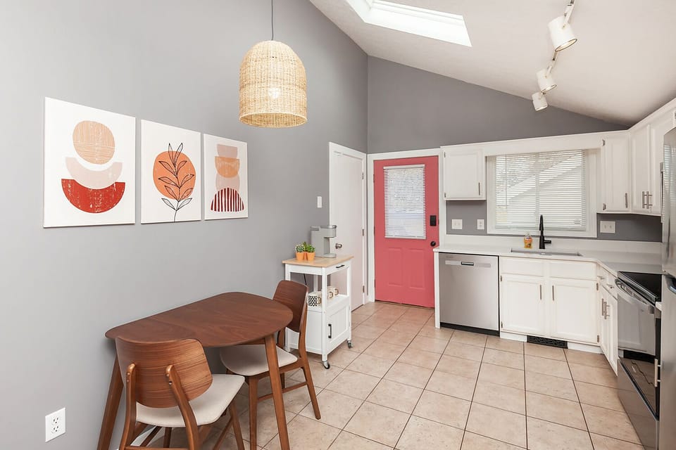 Open kitchen layout with upgrades and dining space for 4 guests. 2 at table.