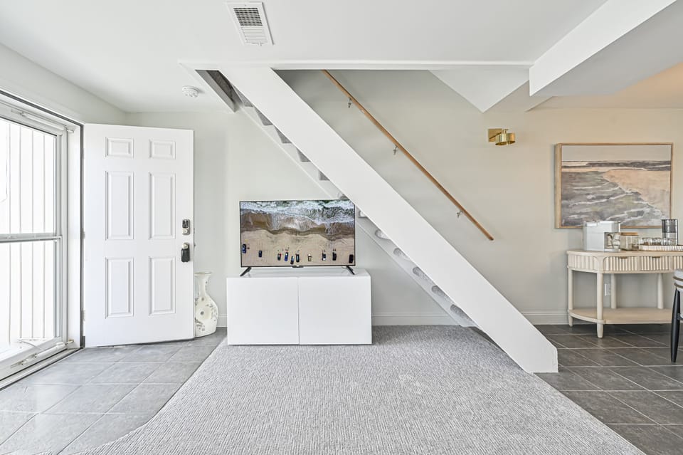 "Floating stairs to a primary suite on the 2nd floor."