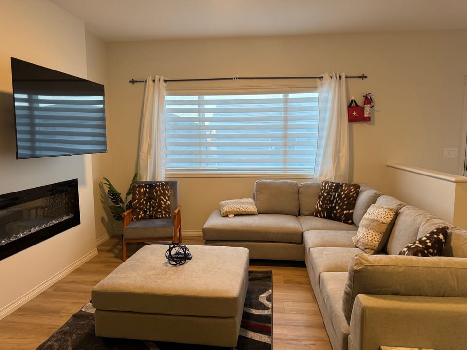 Living room with smart tv and fire place. - Another view