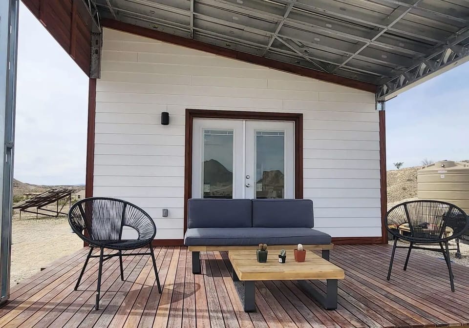 The hardwood deck and inviting front steps provide a warm welcome.