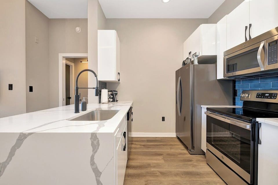 Quartz countertops, Waterfall island, Stainless steel appliances 