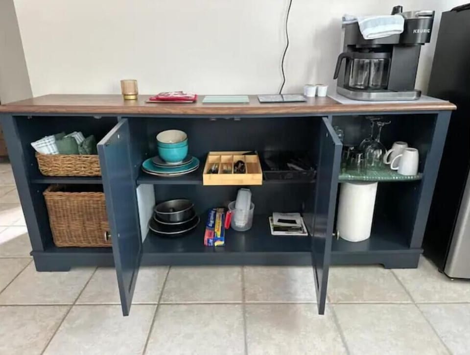 Plates, bowls, utensils, glasses, coffee mugs, wine glasses for two.