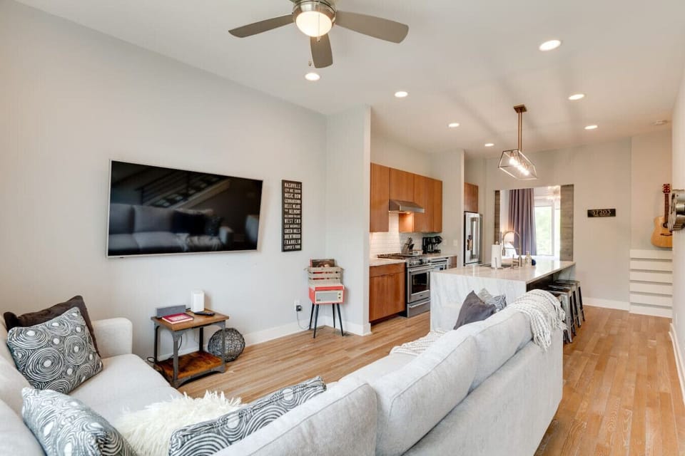 Bright first‑floor living area with comfy seating and TV.