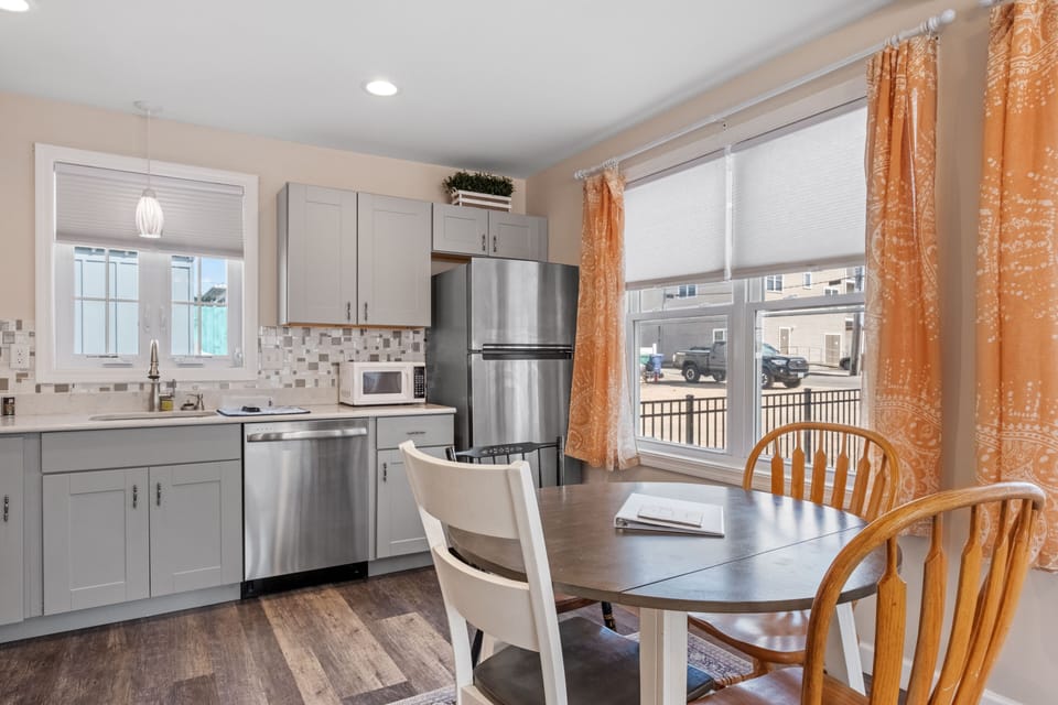 Kitchen is equipped with modern appliances including dishwasher.