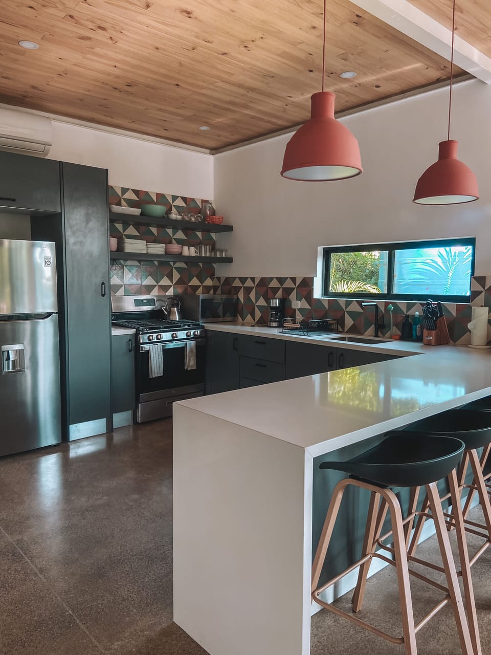 The full kitchen features a full-size stove and oven, microwave and more.